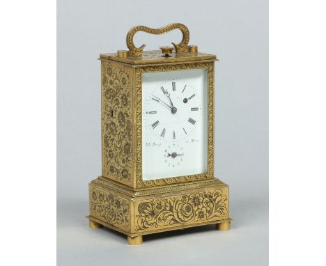 A Biedermeier ormolu carriage alarm clock by Anton Liszt, Wien. Engraved with flowers and scrolling foliage and raised on a s