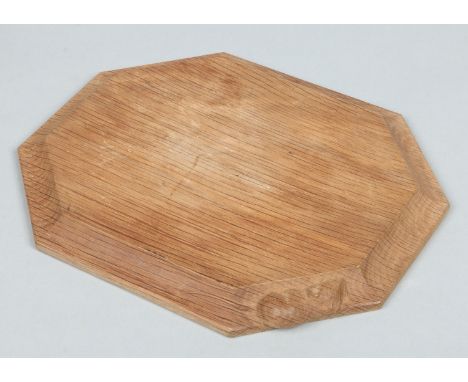 A Robert Mouseman Thompson carved oak cheese board of canted rectangular form and with a model of a mouse at the edge, 30.25c