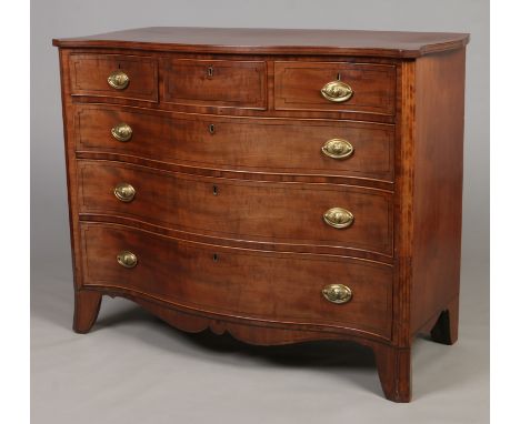 A George III mahogany serpentine chest of three over three drawers. With canted corners and raised on splay bracket supports.