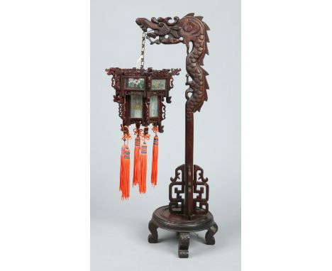 A Chinese early 20th century decorative mulberry lantern. The stand carved in the form of a dragon and its shade with glass p