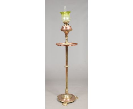 A Victorian brass and copper standard oil lamp. With a green flash and etched glass shade, raised on a reeded column support 