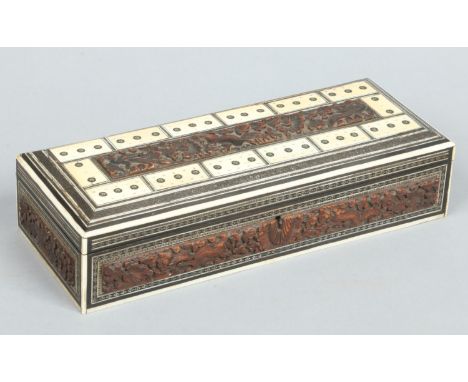 A 19th century Anglo Indian carved sandalwood cribbage board. With ivory top and decorated with micro mosaic bands, 29.5cm. C