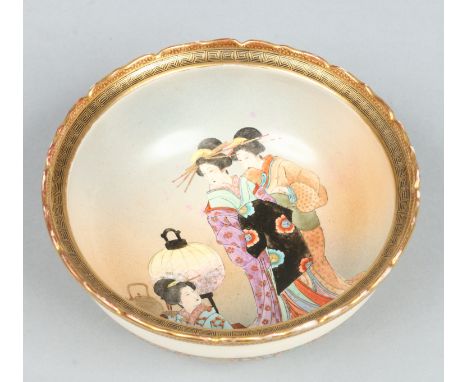 A Japanese Meiji period Satsuma bowl. With scalloped rim, painted in the well with three bijin, one seated by a kettle and pa