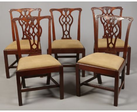 Five matching Chippendale period carved mahogany dining chairs. With carved scrolls to the cresting rails, with pierced balus