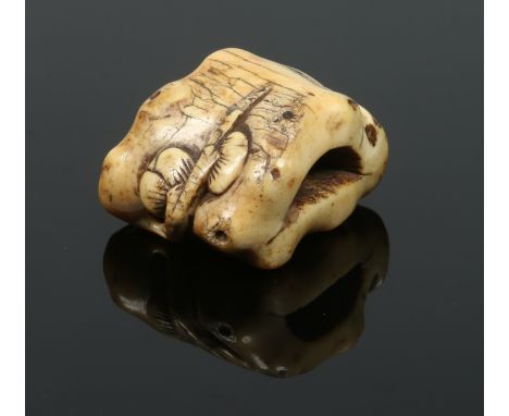 A Japanese early 19th century carved ivory netsuke. Formed as a lotus root issuing plants, 3.75cm wide.  Condition Report. To