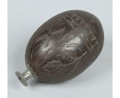 An 18th century carved coconut bugbear powder flask. With pewter nozzle and incised with a crucifix, British ensign, clover a