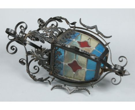 A wrought iron, stained and leaded glass lantern, 68cm.