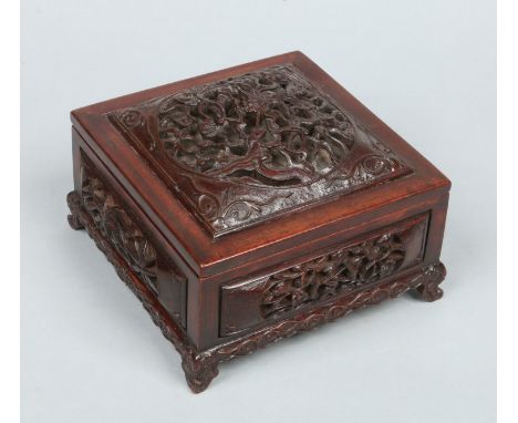 A 19th century Chinese carved and reticulated hardwood box of square form and with fitted internal tray. The domed cover orna