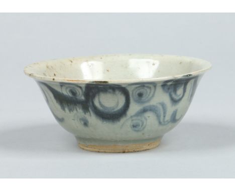 A Chinese provincial Ming dynasty bowl with everted rim. Painted in underglaze blue with a scroll work pattern, 14cm diameter