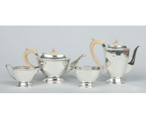 A silver four part tea and coffee service by John Turton & Co. With gardrooned rims, hardwood handles and knops and raised on