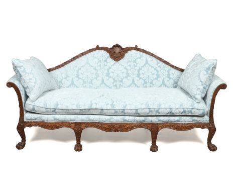 A Chippendale style mahogany camel back upholstered three seat settee. With reeded acanthus cresting rail with shell motif, h