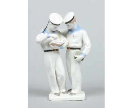 A Lomonosov Soviet porcelain figure group. Modelled as a pair of Naval Cadets (Nakhimovtsys) stood together reading from a bo