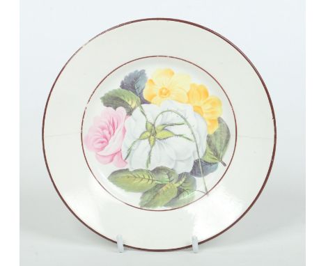 A small Don pottery plate. Decorated in coloured enamels with botanical specimens of roses and primroses under brown line bor