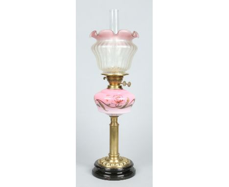 A Victorian brass based oil lamp with Eltex burner. Having cranberry tint etched glass shade and cranberry blush font enamell