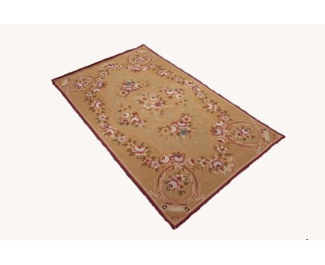 FRENCH TAPESTRY RUG, with an oval centre medallion on roses, rose border and spandrels, on buff field, 5' x 3' 