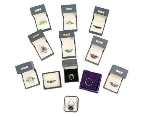 Twelve silver gemset rings, including a jet ring with Celtic design shoulders and a garnet two row cluster ring, amethyst clu