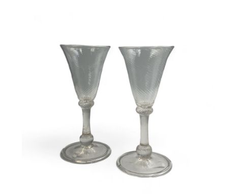 Pair of 18th century Liege wine glasses, circa 1730, with wrythen fluted trumpet bowls and knopped stems, H14.5cm