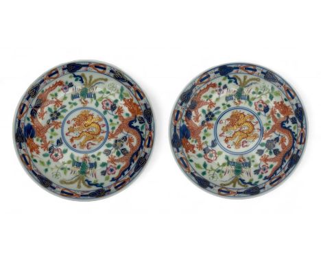 Pair of Chinese 'Dragon & Phoenix' porcelain saucers, centrally painted with a five claw dragon chasing the flaming pearl in 