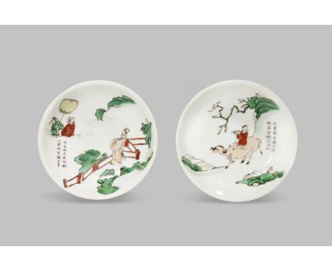 A RARE PAIR OF INSCRIBED CHINESE SAUCERS TRANSITIONAL C.1640 One painted with a boy playing a flute, riding a buffalo on a mo