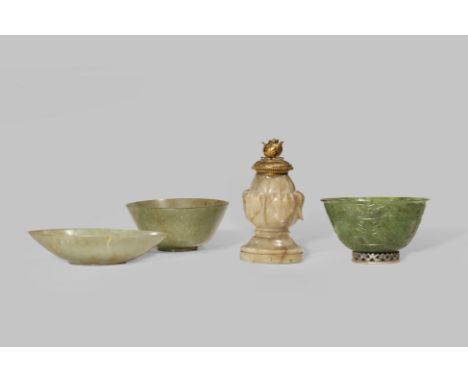 THREE JADE BOWLS 19TH CENTURY One a spinach-green, carved in shallow relief with lotus flowerheads and foliage, the foot moun