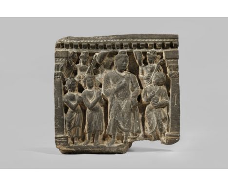 A GANDHARAN GREY SCHIST ARCHITECTURAL FRAGMENT C.2ND CENTURY AD Depicting a scene of Buddha lecturing three disciples, with t