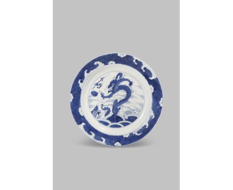 A CHINESE BLUE AND WHITE 'WATER DRAGON' DISH KANGXI 1662-1722 Painted to the centre with a dragon and a carp emerging from sw