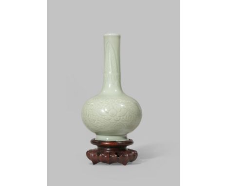 A RARE CHINESE CELADON BOTTLE VASE KANGXI 1662-1722 The ovoid body incised with stylised lotus flowerheads and foliage, with 