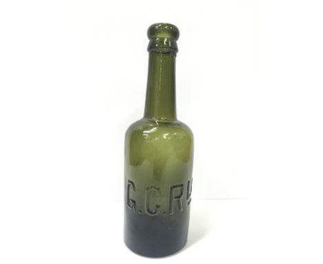 A Green Glass Beer Bottle 8ins High with raised lettering G.C.Rly to the main body and the letters R B B to the base. R B B w