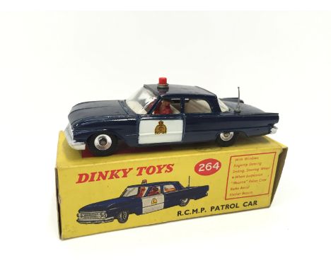 Dinky Toys 264 RCMP Ford Fairline Patrol Car in dark blue with white doors, aerial, beacon and two Mounties. Appears G/VG wit