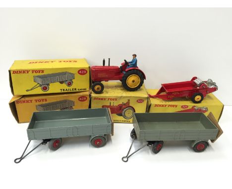 Dinky Toys 300 Massey-Harris Tractor with yellow hubs and blue driver (G+ in P box). Together with three Dinky Toys Trailers: