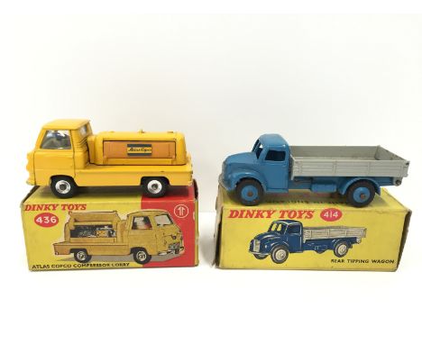Two Dinky Toys construction vehicles: 414 Rear Tipping Wagon in mid blue with mid-blue hubs and light grey back (G+ in G+ box