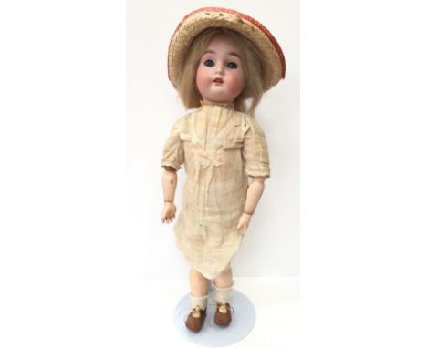 Late 19th/ early 20th century bisque head doll impressed '53' with sleeping blue eyes, eyelashes, open mouth with four teeth,