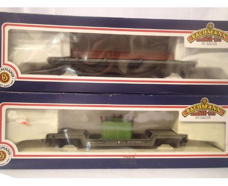 Two OO scale Bachmann wagons; 33-877 45 ton bogie well with transformer and 33-9325 30 ton bogie bolster with steel. Both in 