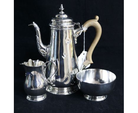 A matched three-piece silver coffee set, London 1961-1963, makers D. & J. Welby Ltd, comprising coffee pot, cream jug and sug