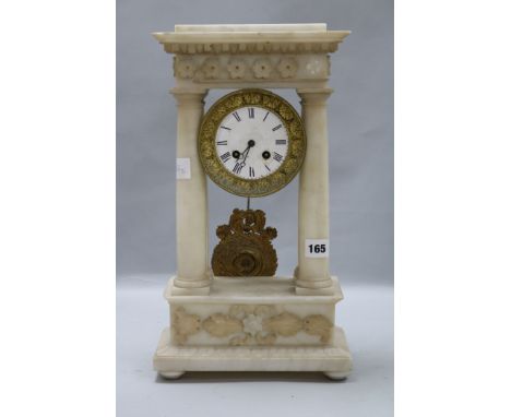 A white alabaster portico clock