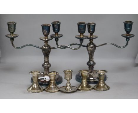 A pair of candelabra and five other dwarf candlesticks