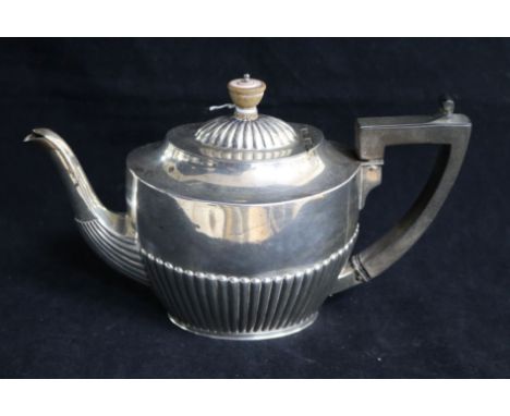 A late Victorian demi fluted silver oval teapot by Army & Navy, London, 1888, gross 16 oz.