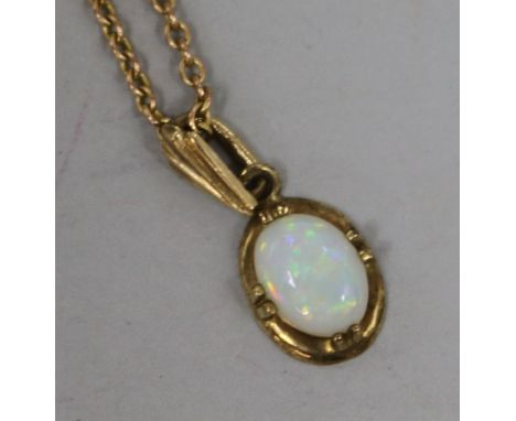 A 9ct gold and white opal oval pendant on a 9ct gold chain, chain pendant 11mm.