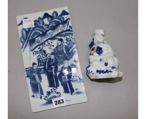 A Chinese blue and white plaque and a Chinese blue and white candlestick