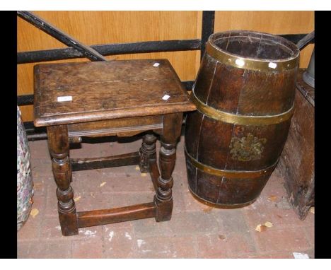 An antique joint stool, together with a brass bound antique stick stand with crest to the front 