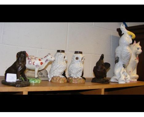A Staffordshire cow creamer, a J.T Jones ceramic cockatoo, a Plichta ceramic cat, pair of ceramic owl lamp bases etc.CONDITIO