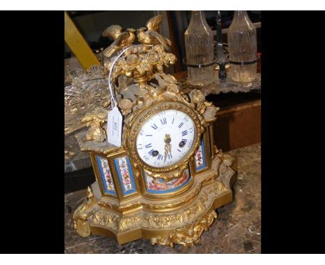 A French ormolu mantel clock by Leroy of Paris, having sevres style panels - 30cms high
