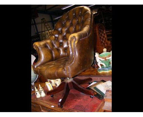 A reproduction button back swivel tub armchair  