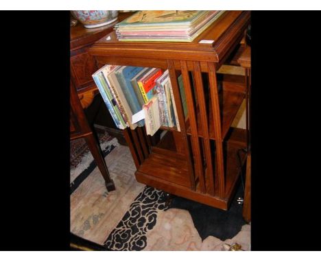 A walnut two shelf revolving bookcase 