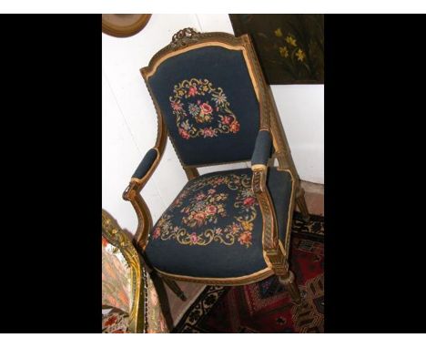 A pair of antique French armchairs with reeded front supports and tapestry seat and back rests