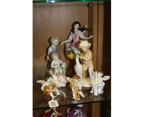 A GROUP OF CERAMIC FIGURES, to include three Volkstedt musical cherub figures, a Schaubach-Kunst figure group of cherub with 