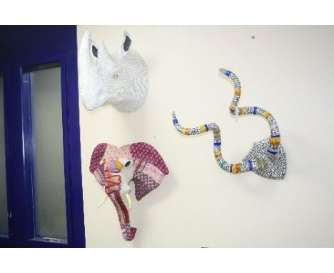 THREE NOVELTY WALL HANGINGS, shaped as a set of horns (covered in wrapping), a paper mache Rhino head (wrapped in French news