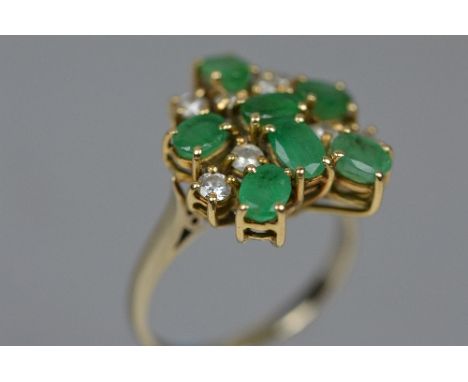 A LATE 20TH CENTURY EMERALD AND DIAMOND ABSTRACT LARGE CLUSTER RING, head measuring approximately 18mm x 16mm, estimated tota