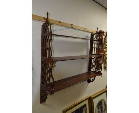 A REPRODUCTION MAHOGANY GRADUATED THREE TIER WALL SHELF, with pierced sides, approximate size width 93cm x height 92cm