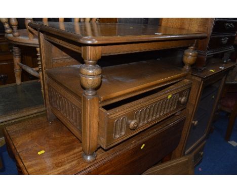 AN ERCOL GOLDEN DOWN TV STAND WITH A SINGLE DRAWER